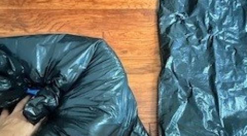 After inserting pillows in the first garbage bag, squeeze out excess air before inserting it in the second bag and then into the fireplace to air seal the flue