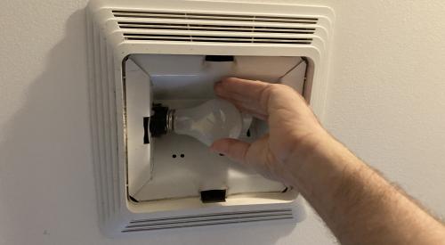 Remove the light bulb from the light fixture in the exhaust fan and clean the light housing with a vacuum brush attachment or cloth
