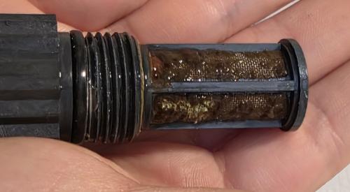 This water filter from a tankless water heater is very clogged with debris