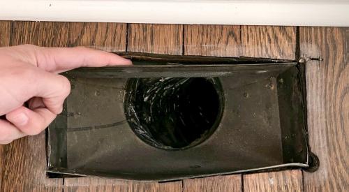 This air register has noticeable gaps between it and the floor; use canned spray foam to fill in the gaps.