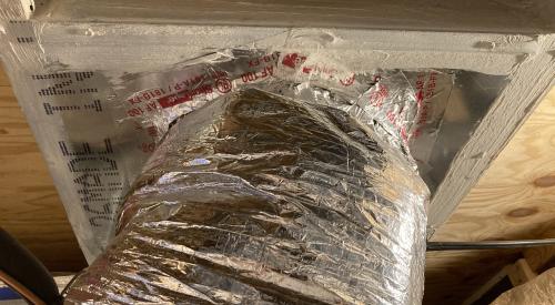 The large hole that was cut in the subfloor penetration for this HVAC duct has been air-sealed using sheet metal, mastic, and metal tape.