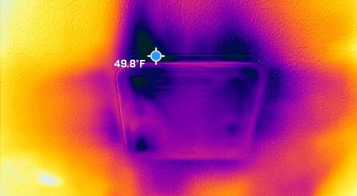 The dark spots and streaks on this infrared camera photo clearly show cold air leaking in through gaps around a bathroom exhaust fan