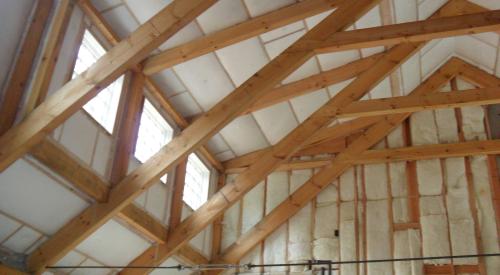 The walls and ceilings of this post-and-beam home are filled with netted blown fiberglass.