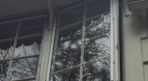 These storm windows are attached to operable casement windows, allowing for ventilation and fresh air when desired.