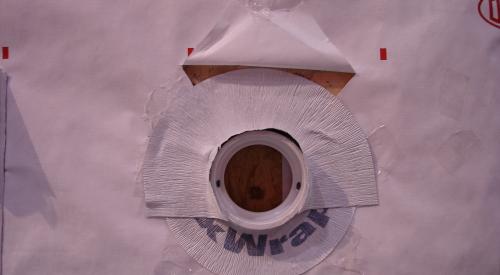 Housewrap is layered over the top edge of this flexible flashing.