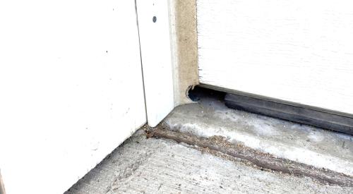 An investigation of this garage door weatherstripping shows that the installed seal wasn’t long enough to extend across the entire length of the door and it appears that rodents chewed into the weatherstripping on the right to make the hole even larger.