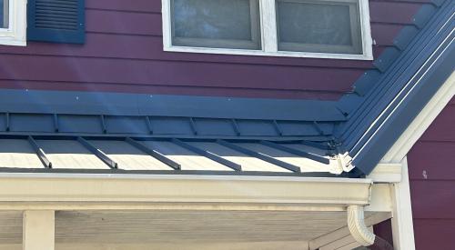The metal flashing used at this wall-to-roof transition is incorrectly layered over, not under, the siding, and is nailed into the siding, creating holes where water can infiltrate the wall 