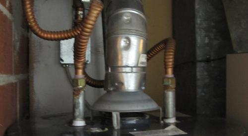 The raised hood at the base of the vent stack on this water heater shows that it is an atmospheric vented gas water heater