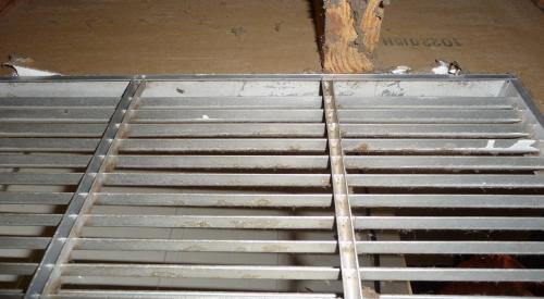 Wrong: open wall cavity connected to this return air plenum is allowing cellulose attic insulation to be pulled into the furnace