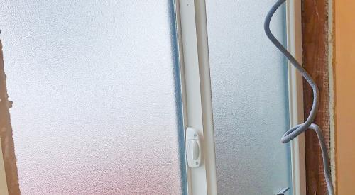 Closed-cell foam backer rod is installed into the rough opening around this existing window to provide air sealing.