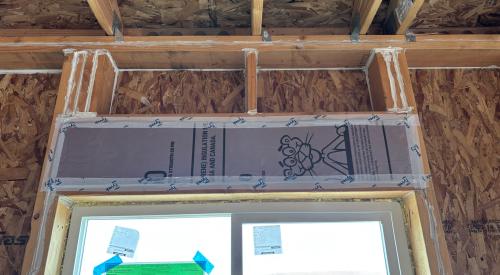 This window header has been insulated with rigid foam and air sealed with house wrap tape and all wood-to-wood joints are caulked.