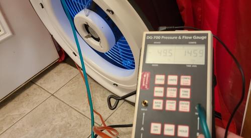 The hoses on this manometer are correctly connected with the red hose connected for the house with reference to outside and the green hose connected for the fan with reference to the house for a blower door test to show air leakage by pressure differences when the house is depressurized to about 50 Pascals.