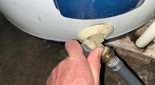 This water heater drain valve is operated by hand.