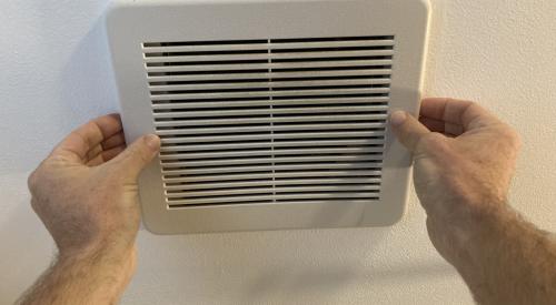 Pull the exhaust fan vent cover down gently to access the spring-loaded mounting wires