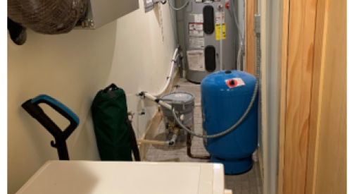 Right: This heat pump water heater is installed in a utility closet where it can use heat from the clothes washer and heat pump clothes dryer and has access to a floor drain for condensate