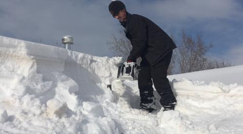 If snow level is estimated to exceed roof load limits, snow removal may be needed; hire professionals 