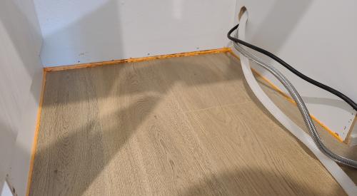 Canned spray foam can be installed with the narrow applicator tip to get a narrow bead of spray foam along this wall-to-flooring seam 