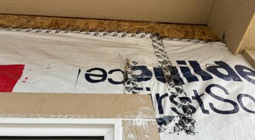 Right – The seams and edges of the house wrap have been taped but house wrap should have been extended up to porch roof and care should be taken to press the tape with a roller to activate tape adhesion.