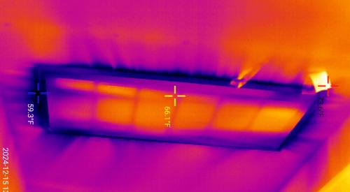 The dark streaks seen in this infrared camera image of a return vent in a ceiling indicate cooler air is leaking in around the vent.
