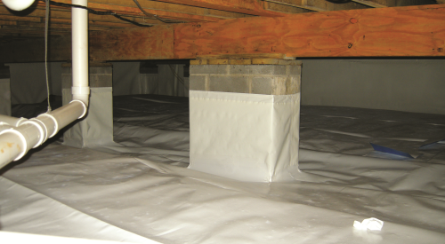Right - The posts and floor of this crawlspace are covered with a heavy sheet of vapor retarder that is sealed to the post, the walls, and at all seams.