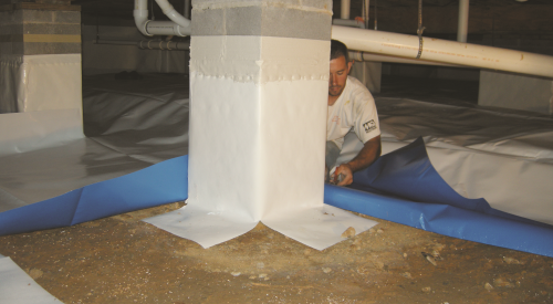 Right - After wrapping the posts, a technician lays a vapor retarder over the floor of a crawlspace. 