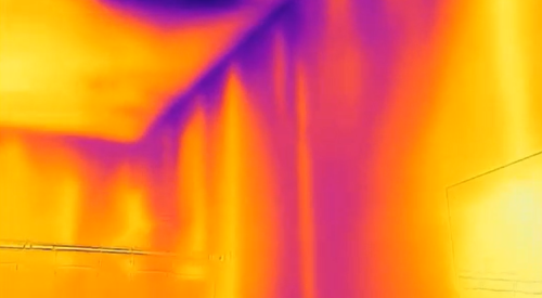 The purple streaks in this IR camera image indicate air leakage along the top plates, which is allowing cold air to be pulled from the attic into the wall cavities of this interior wall. 