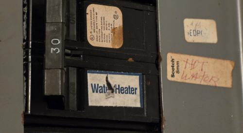 Flip the breaker to turn the heat pump water heater back on after cleaning the air filter