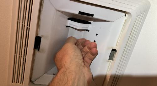 The nut holding the light housing in place in this combination exhaust fan/light can be unscrewed by hand