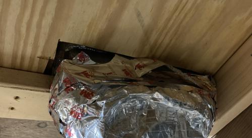 There are large, unsealed gaps where this HVAC duct penetrates the subfloor to supply a floor register; these gaps should be sealed with spray foam.