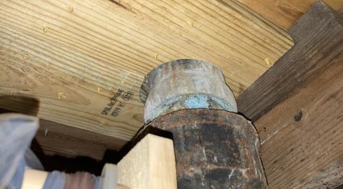 This gap around the wastewater pipe, located under a toilet on the floor above, should be air sealed with caulk or spray foam.
