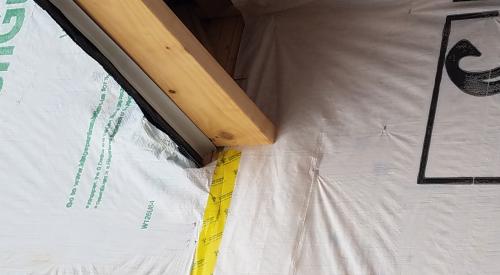 Wrong - House wrap was not properly cut and adhered where the roof meets the wall so water is likely to get behind the house wrap. 