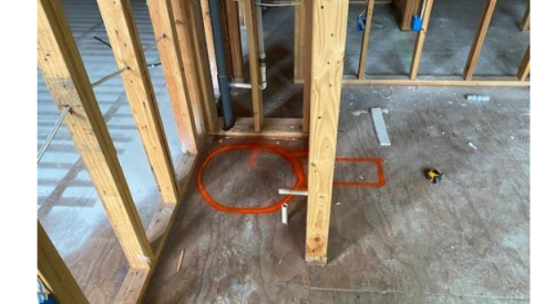 Wrong: Not enough space was left in the floorplans for both the heat pump water heater and a duct elbow to be attached to the right side of the water heater (the orange circle outlines the tank; the rectangle shows the space needed for the duct)
