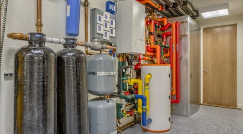 This home’s domestic hot water is provided by three systems: solar water heating panels, a heat pump water heater, and an air-to-water heat pump, which also provides hot water to a fan coil. 