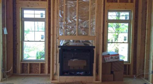 The foil-faced insulation behind this fireplace provides an air barrier and thermal shield. 