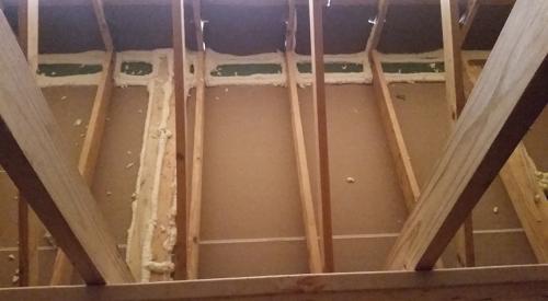 In the attic, all of the top plate seams are sealed with canned spray foam before covering the ceiling deck with blown fiberglass.