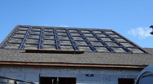 The photovoltaic panels sit in a waterproof plastic tray that was installed directly on the roofing underlayment, then surrounded with roofing shingles. 