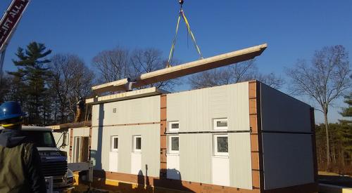The walls and floors of this modular home were constructed in a factory and are brought to the site already insulated and ready for quick assembly.