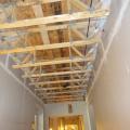 This air-sealing approach uses the wall drywall to isolate the corridor from the individual units in a multifamily building that has a truss floor structural system