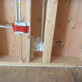 Right - Comprehensive air sealing of the walls includes caulking of the subfloor-sill plate seams and corner seams, taping of electrical boxes, and spray foaming around pipe penetrations.