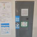 Home performance program labels are displayed on the electric panel showing the certifications this home has receivied, including ENERGY STAR Certified Home, the EPA Indoor airPLUS, and the Home Energy Rating System (HERS) score.