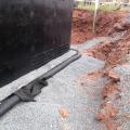 Interior and exterior footing drains keep moisture away from the foundation. Spray-on water proofing helps the concrete foundation walls resist moisture.