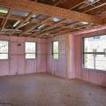 Right - The rigid metal HVAC ducting is installed between the floor joists rather than in an unconditioned attic or crawl space to minimize heat loss.