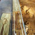 A sill-sealing foam gasket is placed under 8-inch plywood base and two beads of caulk air seal the 2x6 sill plate to it; two more beads of caulk will top the 2x6 which will serve as a spline for the SIP wall panel.