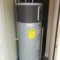 This heat pump water heater is centrally located in a laundry room so that all hot water uses are less than 15 feet from the tank.