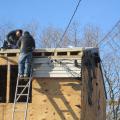The existing 2x8 roof rafters were topped with OSB; two layers of 2-inch rigid foam; plywood; ice and water shield at rakes, eaves, and valleys; underlayment; and fiberglass shingles, plus 6 inches of open-cell foam under the decking.