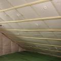 Underneath the roof sheathing and two exterior layers of rigid foam, the builder stapled netting to the underside of the rafters and filled the roof cavities of the unvented attic with blown-in fiberglass insulation.