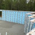 Right - Precast concrete basement walls come to the site with integrated rigid foam insulation and steel-faced concrete studs.