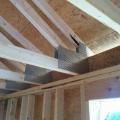 Right - Raised-heel trusses increase the roof height above the eaves allowing more space for insulation above exterior wall top plates; exterior wall sheathing extends up to keep wind from soffit vents from disrupting insulation.