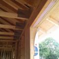 Rigid foam is sandwiched between lumber to form insulated headers over windows. 