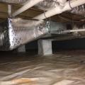 Right - the vapor barrier is extended up the sides of the piers in this crawlspace, which is sealed and insulated to house the HVAC ducts.